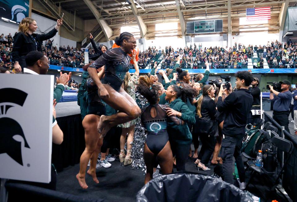 Michigan State celebrates as the results are revealed showing them winning the championship in the 2024 Big Ten Women's Gymnastics Championships, Saturday, March 23, 2024, in East Lansing, Mich.