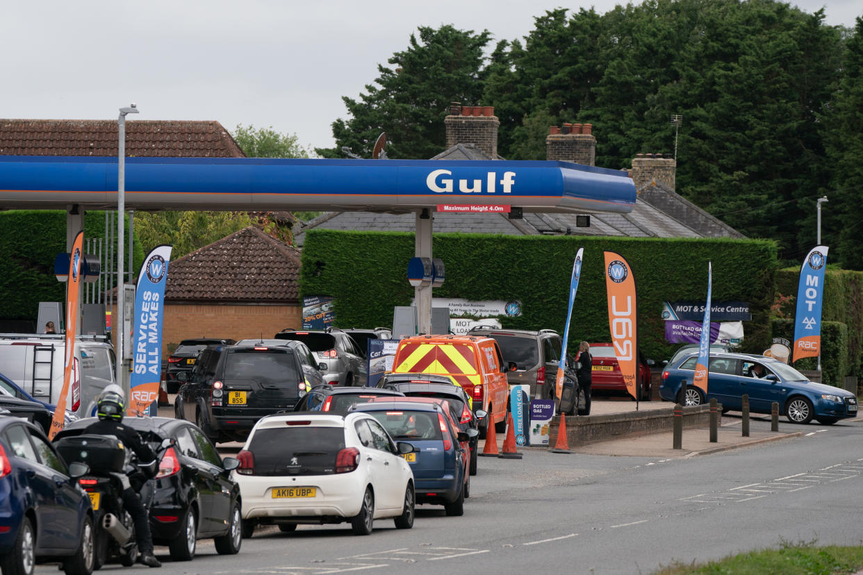 People queue for fuel at a petrol station in Barton, Cambridgeshire. Picture date: Tuesday September 28, 2021.