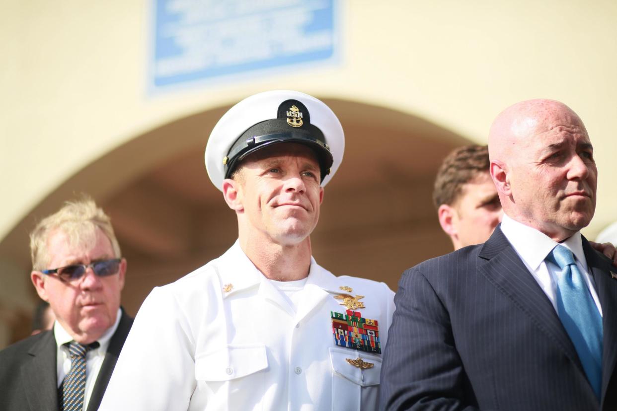 SAN DIEGO, CA - JULY 02:R, Navy Special Operations Chief Edward Gallagher celebrates after being acquitted of premeditated murder at Naval Base San Diego July 2, 2019 in San Diego, California. Gallagher was found not guilty in the killing of a wounded Islamic State captive in Iraq in 2017. He was cleared of all charges but one of posing for photos with the dead body of the captive. (Photo by Sandy Huffaker/Getty Images): Getty Images