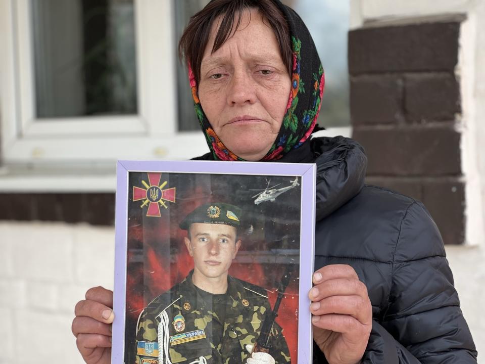 Olena Balai holds a photo of her only son, Viktor Balai, a 28-year-old veteran of the war, in Zdvyzhivka, Ukraine on April 30, 2022. Olena identified his body in eastern Ukraine's Donbas region, on the forest floor. "His brain was leaking out of his head," she said. "The face and mouth were torn apart, the teeth knocked out. There was no space left alive on his body. What pain he bore." She was weeping even as she spoke, her voice a wail of words. "Who would torture a kid?" she said. "I want them to be found and punished." Viktor was her only son. "I have no one else," she said, struggling to breathe. "I don't know how to continue my life." (AP Photo/Erika Kinetz)