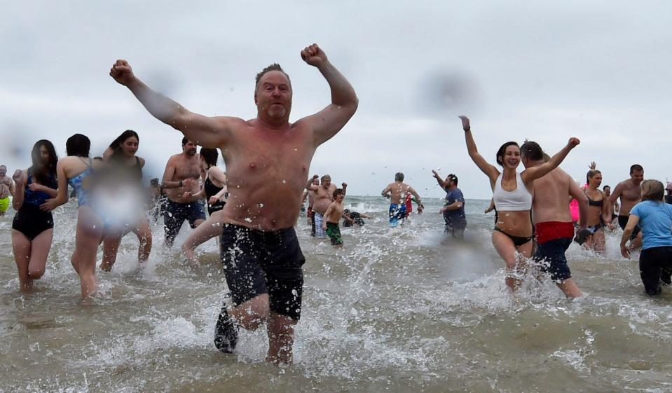 Swimmers welcome a New Year by racing into Lake Michigan during a past Jacksonport Polar Bear Swim, which takes place Jan. 1 for the 38th time. File/USA TODAY-Wisconsin