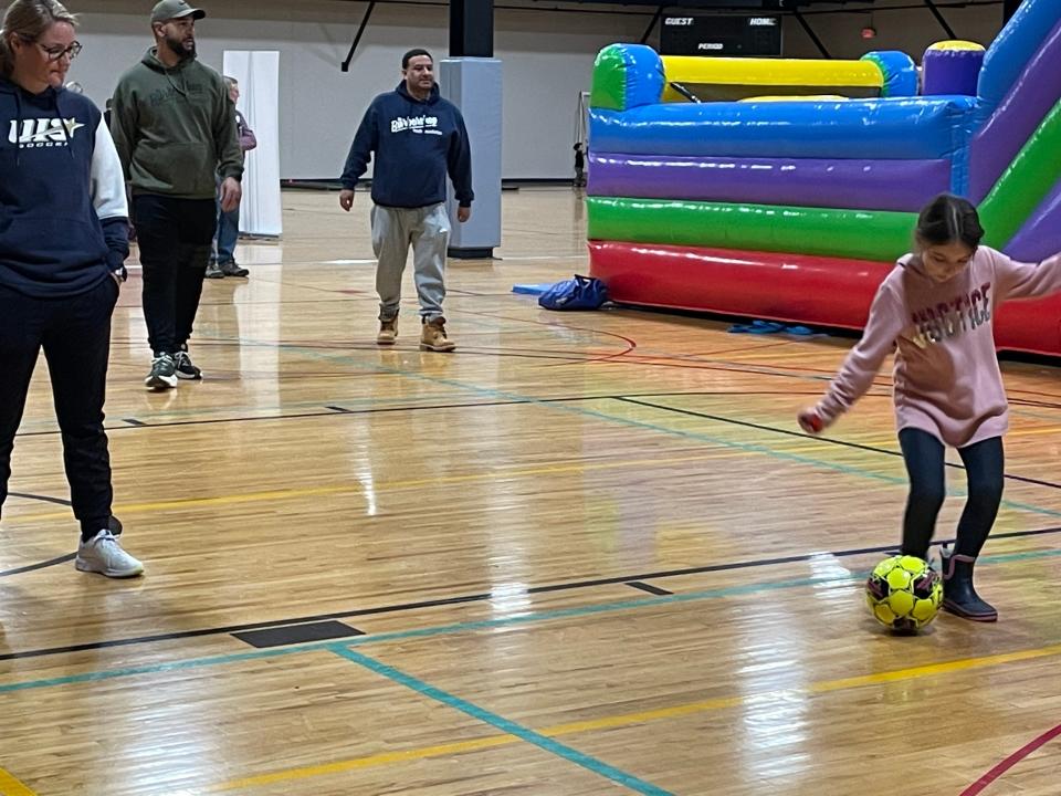 Layla Fulkerson, 7, puts in a shot on goal Saturday, Jan. 28, 2023 at the Springfield Downtown Kiwanis Kidsbash at the Salvation Army.