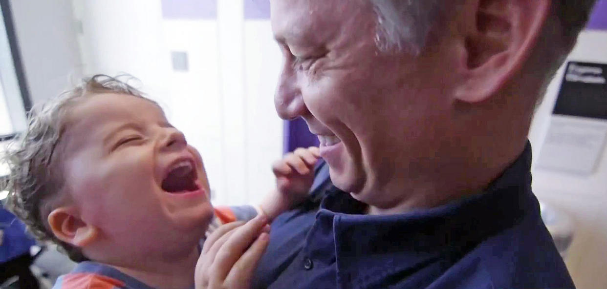 Henry Engel smiles and laughs as his father, Richard Engel, holds him. (TODAY)
