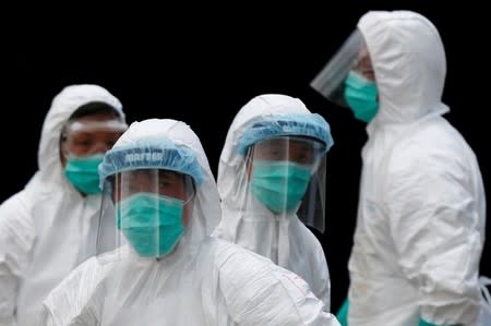 FILE PHOTO: Health officers in protective clothing cull poultry at a wholesale market in Hong Kong