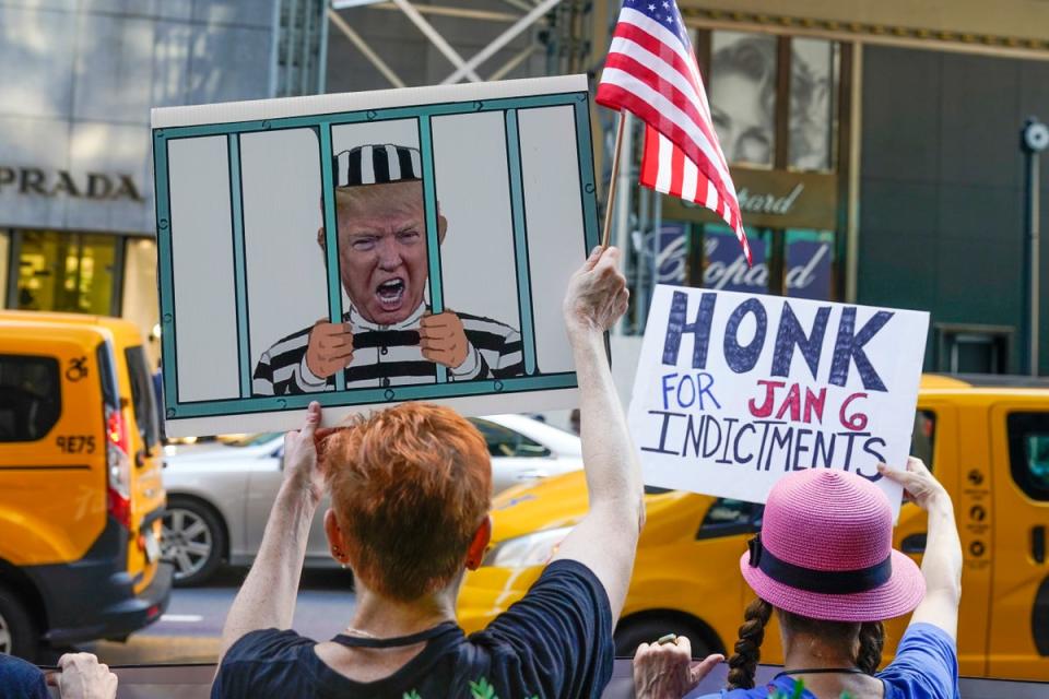 Protesters stand in front of Trump Tower in New York after news that the FBI had searched former president Donald Trump’s Mar-a-Lago home in Florida (AP)