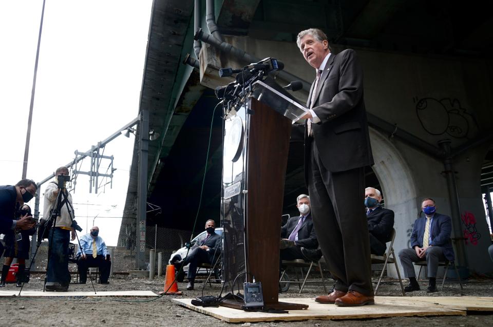 Gov. Dan McKee speaks about road and bridge construction last spring.