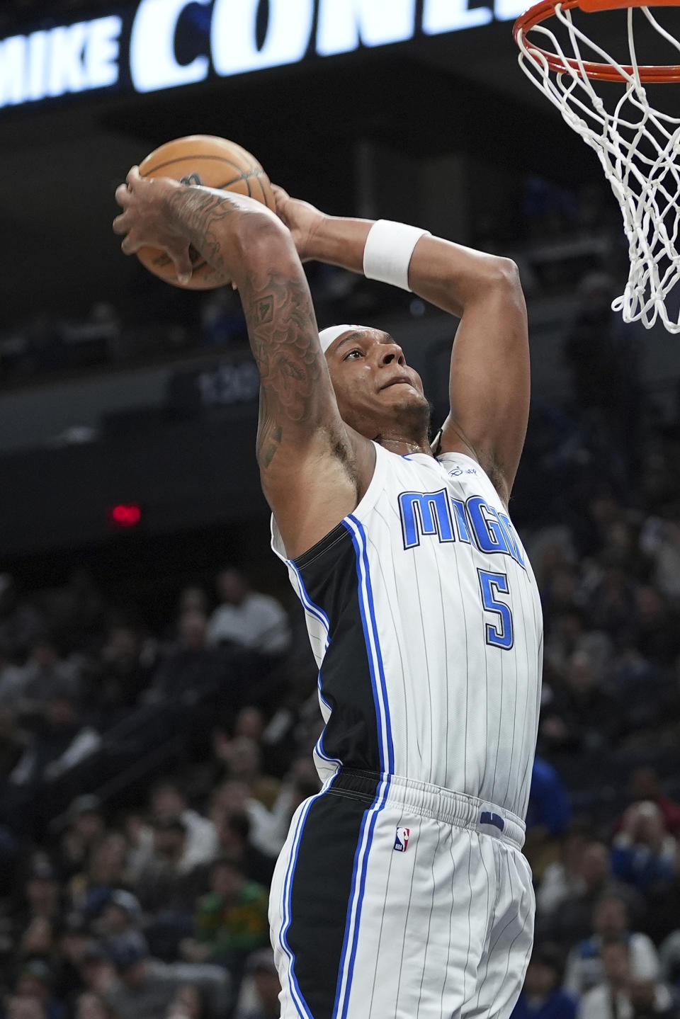 Orlando Magic forward Paolo Banchero goes up for a dunk during the second half of an NBA basketball game against the Minnesota Timberwolves, Friday, Feb. 2, 2024, in Minneapolis. (AP Photo/Abbie Parr)