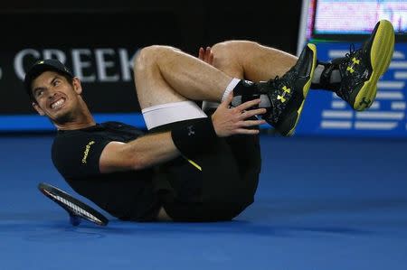 Tennis - Australian Open - Melbourne Park, Melbourne, Australia - 18/1/17 Britain's Andy Murray holds his ankle after falling during his Men's singles second round match against Russia's Andrey Rublev. REUTERS/Thomas Peter