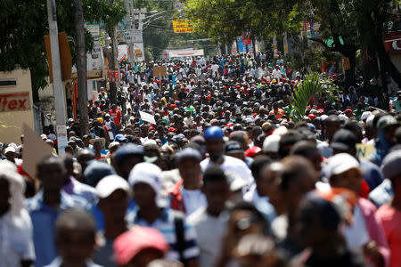 Protesters march to demand an investigation into what they say is the alleged misuse of Venezuela-sponsored PetroCaribe funds, in Port-au-Prince. REUTERS/Andres Martinez Casares