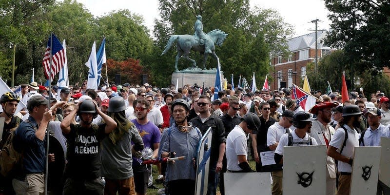 FILE PHOTO: White nationalists gather under a statue of Robert E. Lee during a rally in Charlottesville, Virginia, U.S., August 12, 2017.   REUTERS/Joshua Roberts/File Photo