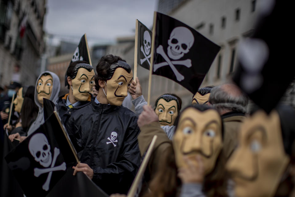 People protest against a law to legalize euthanasia in front of the Spanish Parliament in Madrid, Spain, Thursday, Dec. 17, 2020. The Spanish Parliament debates on votes on a bill to legalize euthanasia for those people suffering "unbearably" from a chronic or incurable disease. (AP Photo/Manu Fernandez)