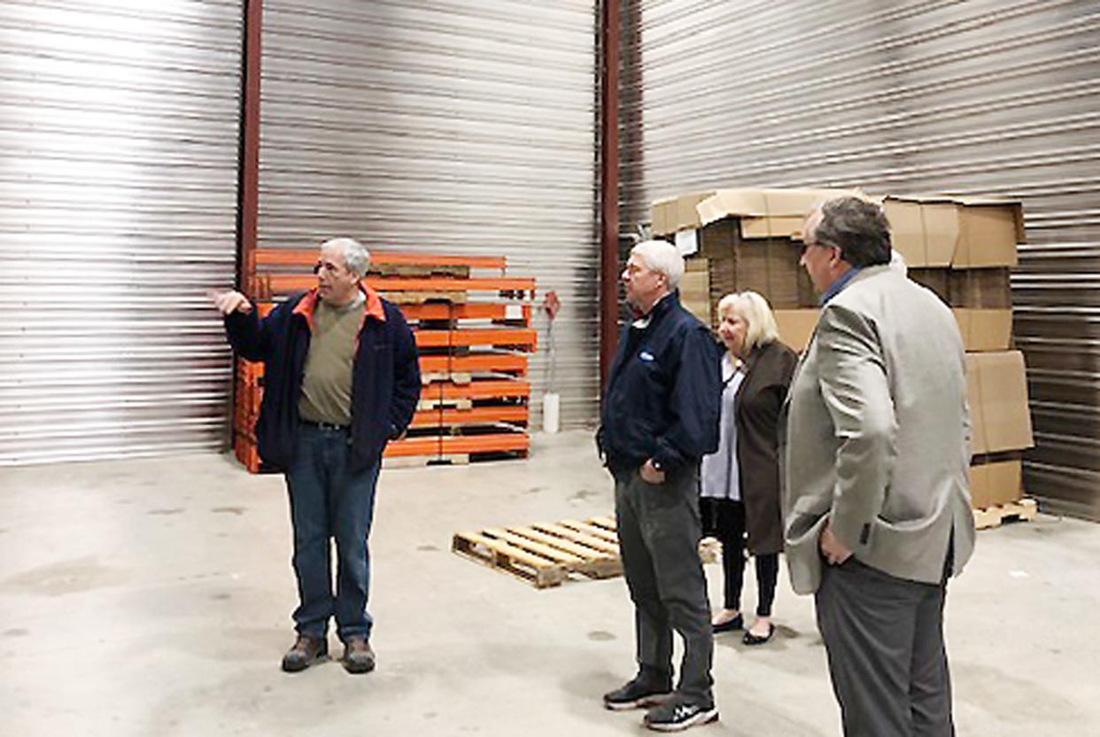 Brad Steidinger, left, shows members of the Fairbury Rotary Club the inside of his new distribution facility in downtown Fairbury.