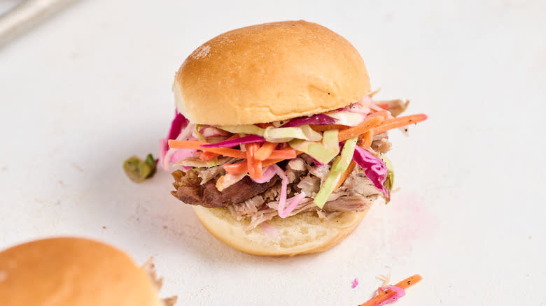pulled pork sandwich with coleslaw on table