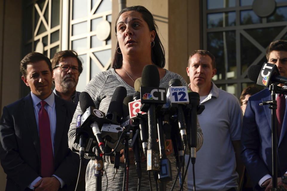 Erica Lafferty, daughter of Sandy Hook Principal Dawn Hochsprung, speaks to the media after jurors returned a $965 million dollar judgement in the defamation trial against Alex Jones, in Waterbury, Conn, Wednesday, Oct. 12, 2022. (AP Photo/Bryan Woolston)