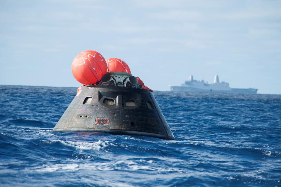 NASA's Orion spacecraft awaits the U.S. Navy's USS Anchorage for a ride home. Orion launched into space on a two-orbit, 4.5-hour test flight at 7:05 am EST on Dec. 5, and safely splashed down in the Pacific Ocean, where a combined team from NASA, the Navy and Orion prime contractor Lockheed Martin retrieved it for return to shore on board the Anchorage. It is expected to be off loaded at Naval Base San Diego on Monday. (Photo by VCG Wilson/Corbis via Getty Images)