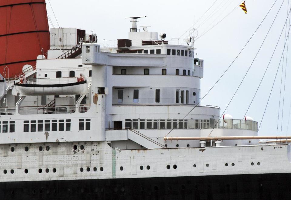 This May 15, 2015 photo shows the retired Cunard ocean liner Queen Mary, with rust patches on its superstructure, at its permanent mooring in the harbor at Long Beach, Calif. A survey has found the ship is so corroded that it's at urgent risk of flooding, and the price tag for fixing up the 1930s ocean liner could near $300 million. Documents obtained the Long Beach Press-Telegram show it would take five years to rehab the ship. Engineers who compiled the survey warn that the vessel is probably "approaching the point of no return." (AP Photo/John Antczak)