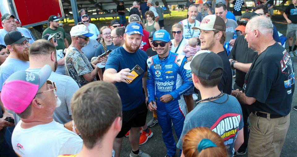 Kyle Larson signs autographs for fans during the CARS Tour 265 at Caraway Speedway in Asheboro, North Carolina, on June 28, 2023.