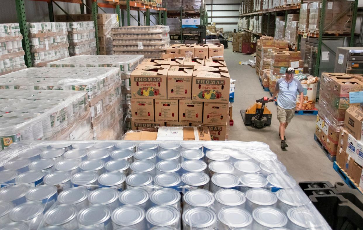 Steve Stager gets set to load food onto a truck at Feeding the Gulf Coast warehouse in Milton in April 2020.