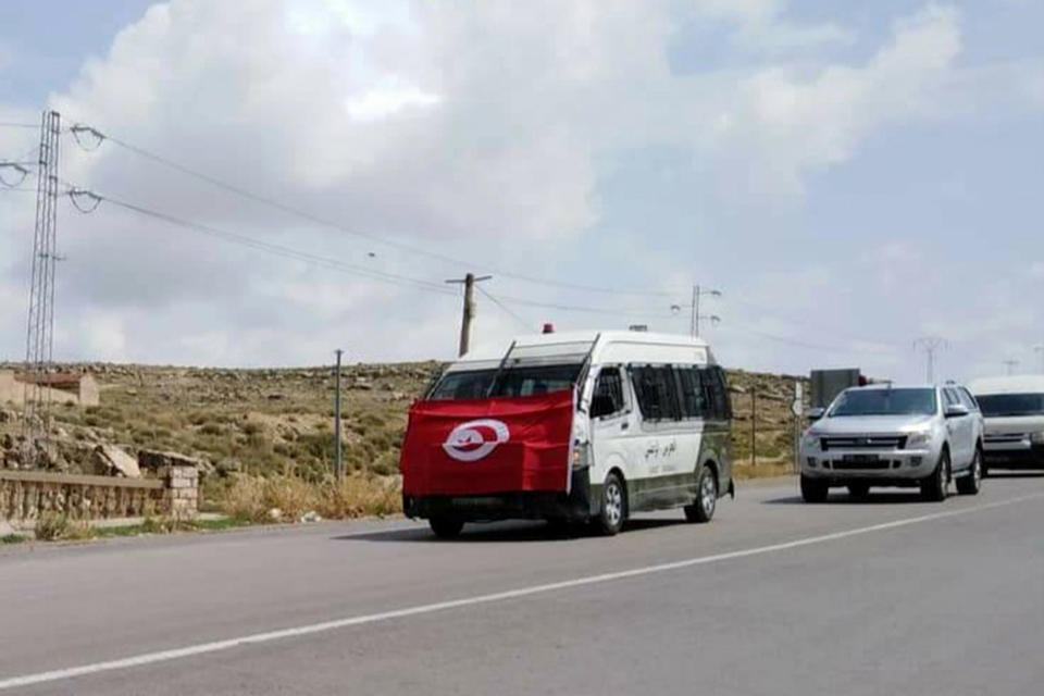 The convoy carrying the body of a slain Tunisian national guard head to is house in Kasserine Monday Sept.2, 2019. A Tunisian national guard chief and three extremists were killed in a clash Monday, on the first day of the country's presidential campaign, authorities said. (AP Photo/Mohamed Ben Salah)