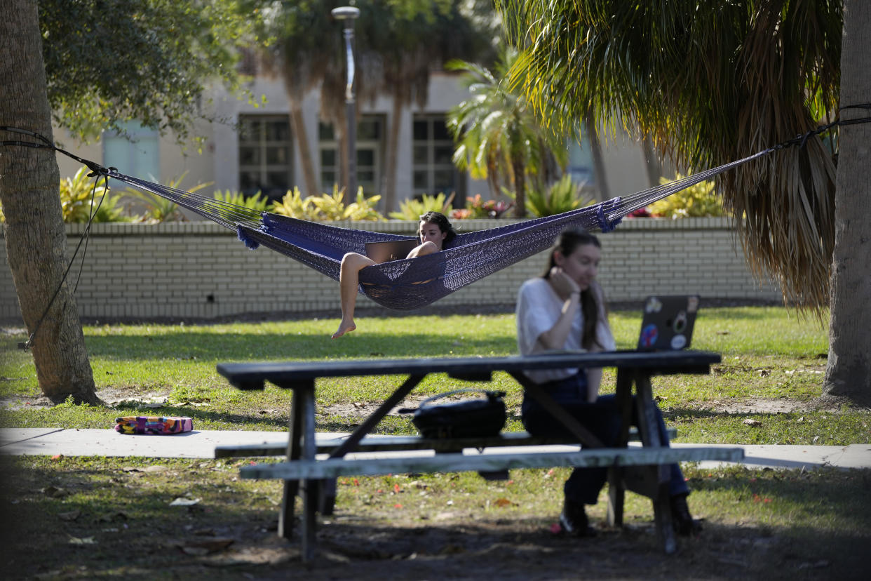 Students work on their laptops on the campus of New College of Florida, Thursday, March 2, 2023, in Sarasota, Fla. New College has long been an anomaly in a state filled with large public universities. It has barely 700 students, no fraternities or sororities and no football team. It is Florida's designated honors college and produces an impressive number of the state's Fulbright scholars.(AP Photo/Rebecca Blackwell)