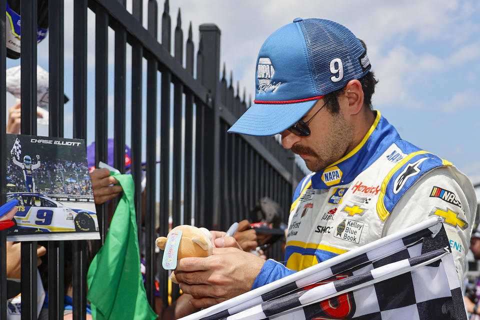 Chase Elliott signs autographs for fans in the garage area prior to the NASCAR Cup Series M&M's Fan Appreciation 400 at Pocono Raceway. (Photo by Tim Nwachukwu/Getty Images)