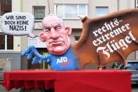 <p>A carnival float, depicting co-leader of the parliamentary group of the Alternative for Germany (AfD) far-right party Alexander Gauland, is pictured during a carnival parade on Rose Monday on Feb. 12, 2018 in Duesseldorf, western Germany. The writings read “We are not nazis at all” (L) and “far-right wing”(R). Germany. (Photo: Patrik Stollarz/Getty Images) </p>