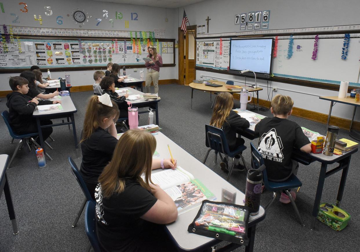 Sydney Guth, MCES third grade teacher, works on a religious exercise with students Thursday at the St. John campus. St. John will not be used after this school year.
