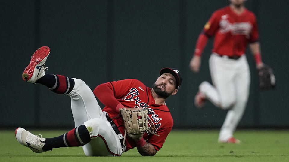 Atlanta Braves left fielder Kevin Pillar (17) catches a ball off the bat of Washington Nationals catcher Keibert Ruiz (20) during fourth inning of an baseball game, Friday, Sept. 29, 2023, in Atlanta. (AP Photo/Mike Stewart)