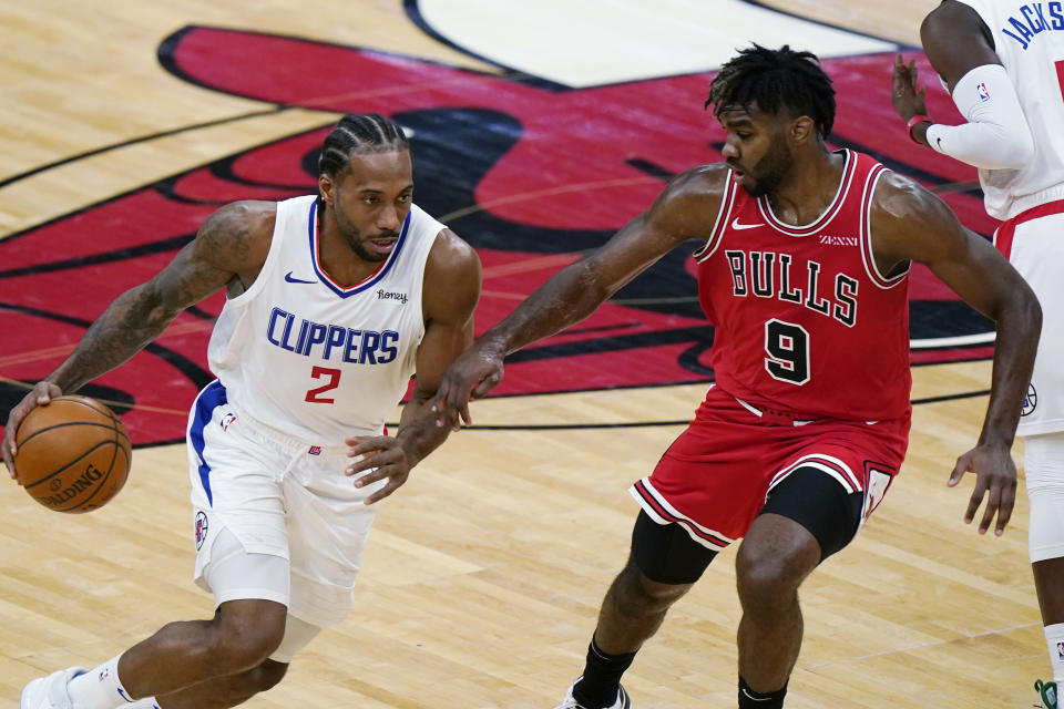 Los Angeles Clippers forward Kawhi Leonard, left, drives against Chicago Bulls forward Patrick Williams during the second half of an NBA basketball game in Chicago, Friday, Feb. 12, 2021. (AP Photo/Nam Y. Huh)