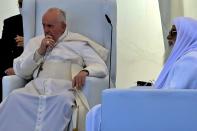 Pope Francis, left, listens during an interreligious meeting near the archaeological site of Ur near Nasiriyah, Iraq, Saturday, March 6, 2021. Pope Francis and Iraq's top Shiite cleric delivered a powerful message of peaceful coexistence Saturday, urging Muslims in the war-weary Arab nation to embrace Iraq’s long-beleaguered Christian minority during an historic meeting in the holy city of Najaf. (AP Photo/Nabil al-Jourani)