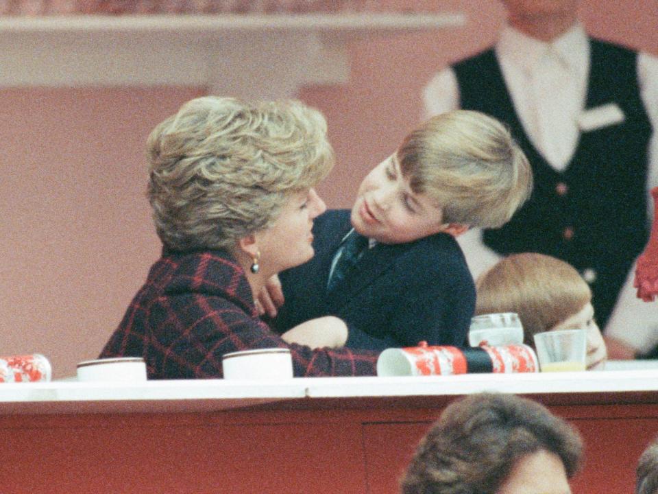 Princess Diana and Prince William hug.