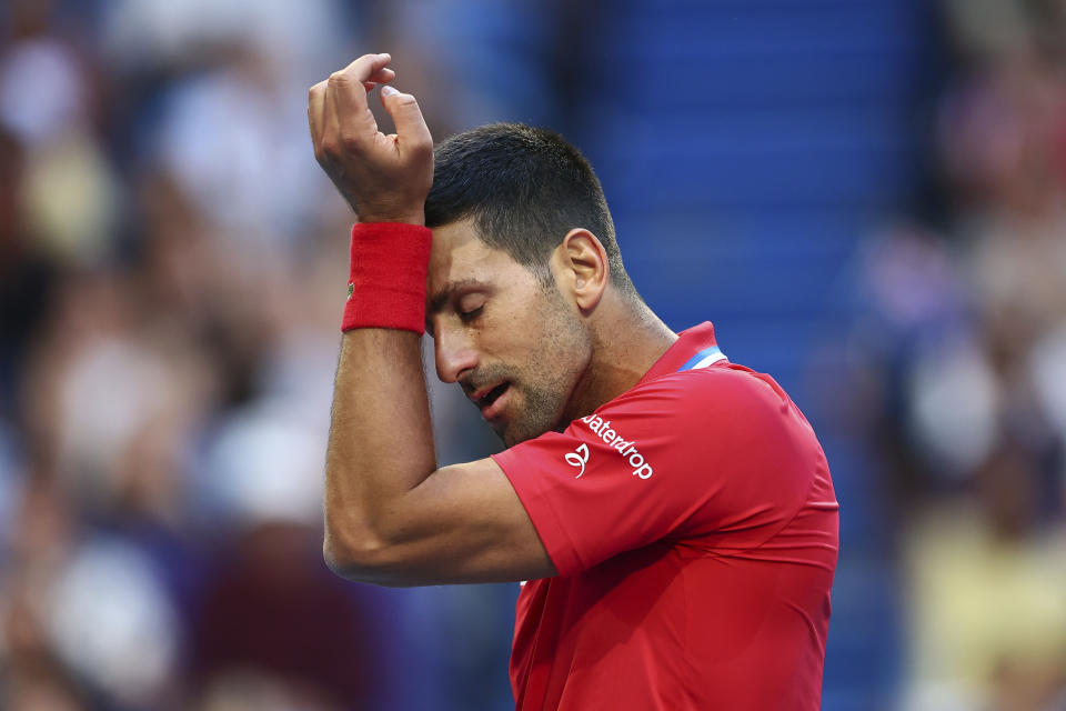 Novak Djokovic of Serbia wipes sweat from his brow during his match against Alex de Minaur of Australia at the United Cup tennis tournament in Perth, Australia, Wednesday, Jan. 3, 2024. (AP Photo/Trevor Collens)