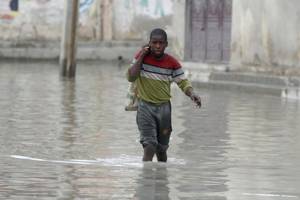 A boy makes his way through flood water caused by heavy rain, in Mogadishu, Somalia, Saturday, Nov. 11, 2023 (AP Photo/Farah Abdi Warsameh)