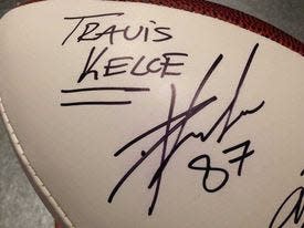 Football player Travis Kelce autographed this football for Berkeley Kemper in cursive and print.