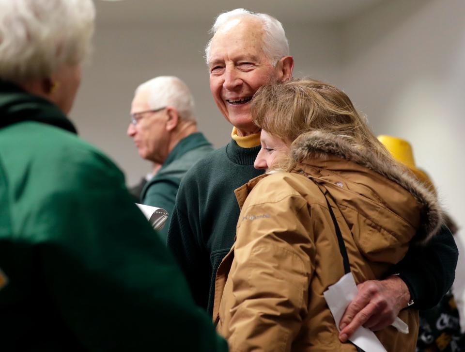 John Breske, the Green Bay Packers FAN Hall of Fame's newest inductee, gets a hug from his daughter, Laurie Breske, following the ceremony at Lambeau Field on Feb. 16 in Green Bay.