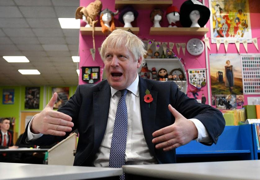 Boris Johnson gestures as he talks with teachers - but not sixh formers - during visit to George Spencer Academy in Stapleford, Nottinghamshire: Getty