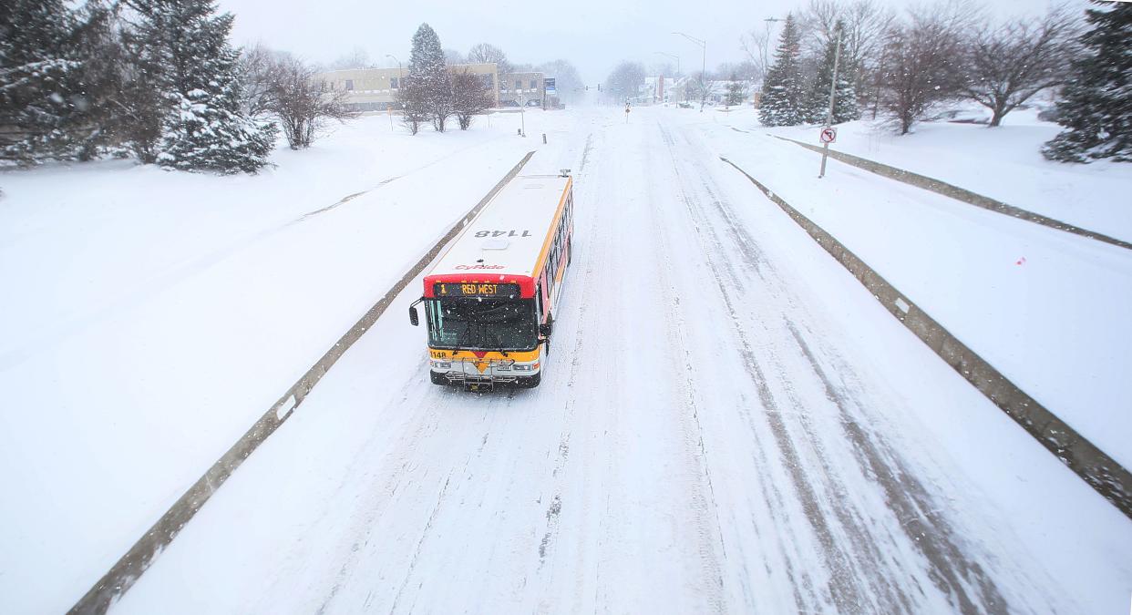 A CyRide bus passes through the empty Grand Avenue during the winter storm on Friday, Jan. 12, 2024, in Ames, Iowa.