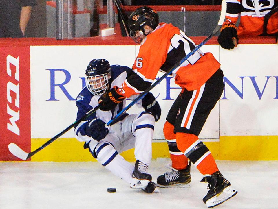 In this Oct. 19, 2021 file photo, a McDowell player, left, is checked by Cathedral Prep's Ethan Cunningham at Erie Insurance Arena. Cunningham was second on the Ramblers this season with 13 assists and 16 points in PIHL Class AAA games.