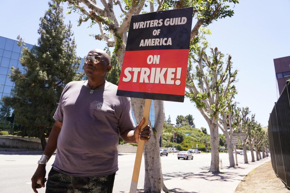 WGA and SAG-AFTRA member Dee Thompson walks past trees