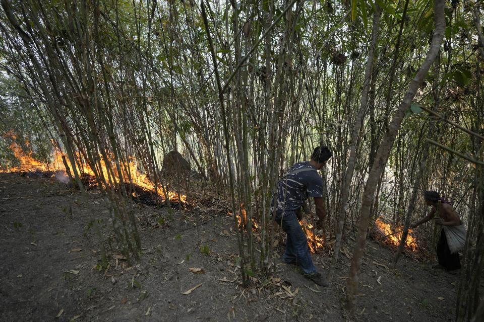 Members of the Pakanyo tribe set a fire in protected forest land at Chiang Mai province, Thailand, Monday, April 22, 2024. The Pakanyo, who have carried out the practice of controlled burns as long as they have lived in these hills near Chiang Mai, a top tourist destination, say they get blamed by city dwellers for fouling the air and damaging forest land. (AP Photo/Sakchai Lalit)