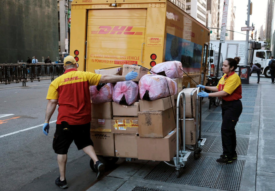 Employees of DHL prepare packages to deliver near Times Square in Manhattan, New York City, New York, U.S., June 13, 2016. REUTERS/Rickey Rogers