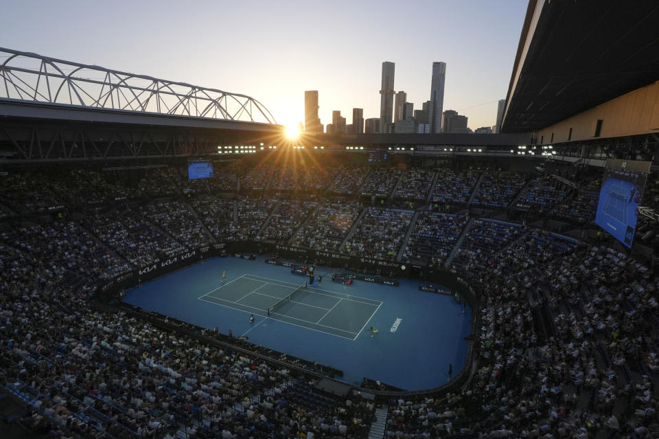 Sunsets over Rod Laver Arena during the quarterfinal match between Zheng Qinwen of China and Anna Kalinskaya of Russia at the Australian Open tennis championships at Melbourne Park, Melbourne, Australia, Wednesday, Jan. 24, 2024. (AP Photo/Andy Wong)