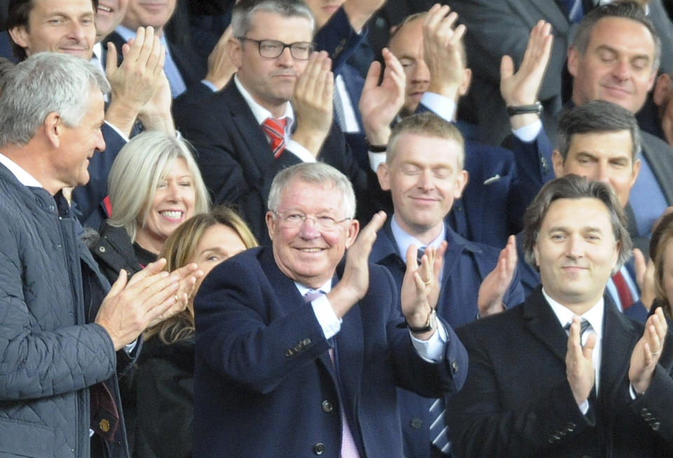 Former Manchester United manager Alex Ferguson, center, applauds as he takes his seat on the stands before the English Premier League soccer match between Manchester United and Wolverhampton Wanderers at Old Trafford stadium in Manchester, England, Saturday, Sept. 22, 2018. (AP Photo/Rui Vieira)