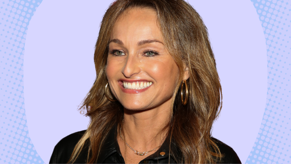 giada de laurentiis wearing a black top on a purple and blue background