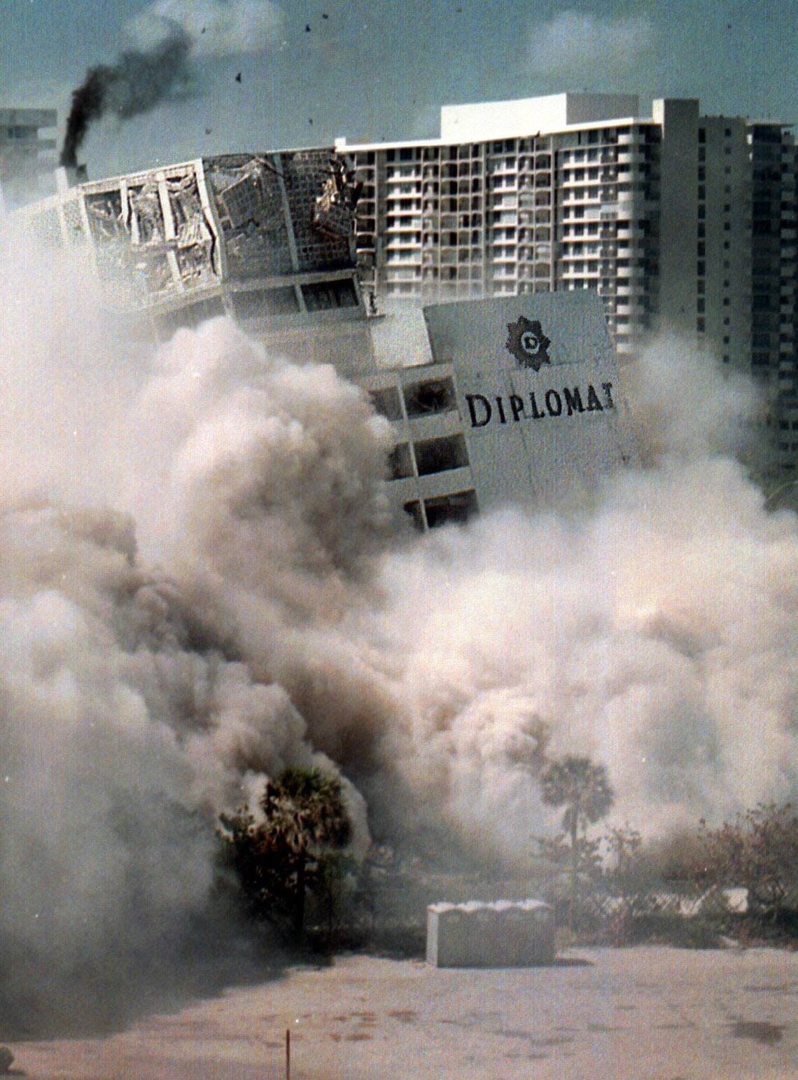 Smoke from the top of the tower of the old Diplomat hotel as it goes over into a pile. The white cloud is dust that came up as the building fell down.