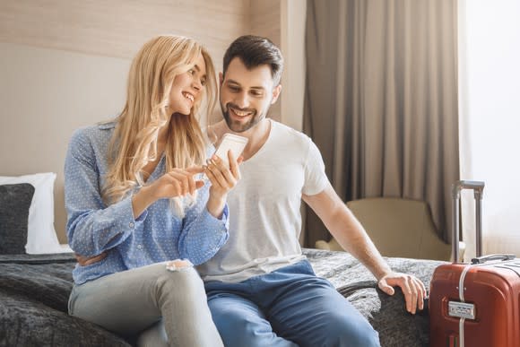 A couple sitting in a hotel room.