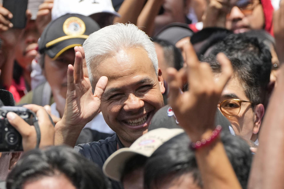 Presidential candidate Ganjar Pranowo greets supporters upon arrival to register to run in the 2024 presidential election at the General Election Commission building in Jakarta, Indonesia, Thursday, Oct. 19, 2023. The battle lines for Indonesia's 2024 presidential election were drawn Thursday as candidates began to formally enroll to run in the election at the country's electoral commission. (AP Photo/Achmad Ibrahim)