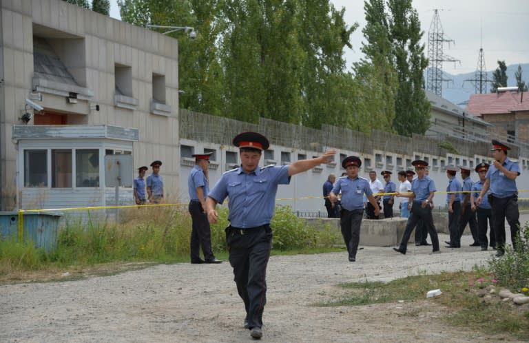 Kyrgyz police cordoned off the area outside the Chinese embassy in Bishkek on August 30, 2016 after a suicide bomber smashed through the gates in a van and detonated a device