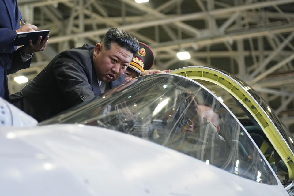 In this photo released by the Khabarovsky Krai region government, North Korean leader Kim Jong Un looks at a military jet cockpit while visiting a Russian aircraft plant that builds fighter jets in Komsomolsk-on-Amur, about 6,200 kilometers (3,900 miles) east of Moscow, Russia, Friday, Sept. 15, 2023. (Khabarovsky Krai region government via AP)