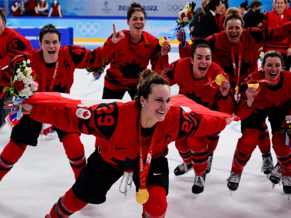 Canada's Marie-Philip Poulin celebrates winning Olympic gold with her teammates, who would also be victorious at the world championships later in the year. (Matt Slocum/The Associated Press - image credit)